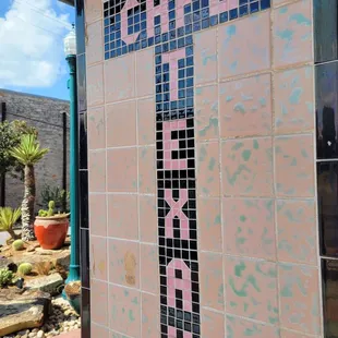 Marquee set in tile at entrance.