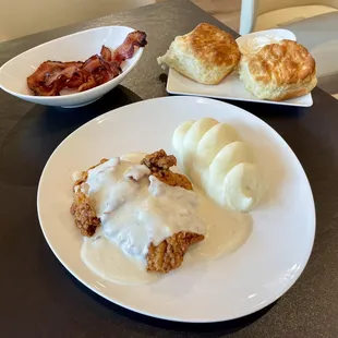 Chicken-fried steak with whipped potatoes. I added the jalapeño bacon and biscuits a la carte, but my server didn&apos;t charge me!