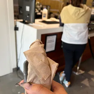 a person holding a piece of paper in their hand