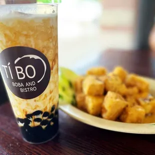 a plate of fried tofu and a drink