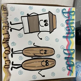 a cardboard box with a couple of hot dogs on it