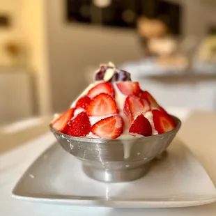 a bowl of strawberries and cream