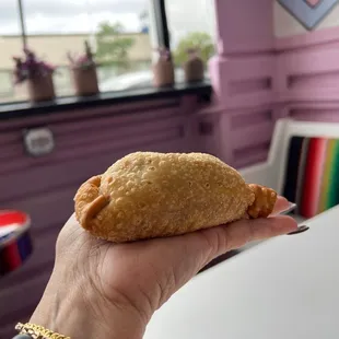 a hand holding a pastry