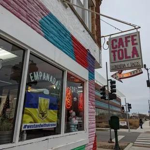 a colorful building with a sign that says cafe tola