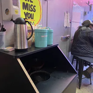 What seating area 2 small tables no place to sit The tables are in between two freezers not a good vibe