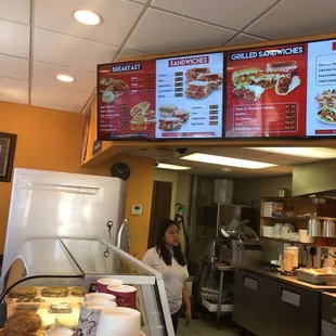 a woman standing in front of a counter