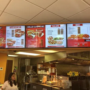 menus on the wall above the counter