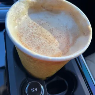 a cup of coffee in a cup holder