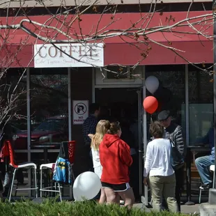 a group of people outside a cafe