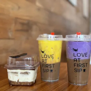 two cups of coffee and a spoon on a table