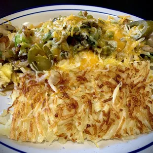 Veggie omelette with jalapeños and a side of hash browns.