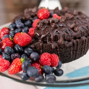 a chocolate cake and berries on a plate