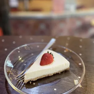 a slice of cheesecake with a strawberry on top