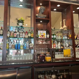 a bar with a lot of bottles and glasses