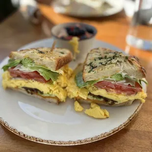 Grilled breakfast sandwich - Eggs over medium, uncured bacon, avocado, red onion, tomato, lettuce, mayo, cheddar cheese on sourdough.