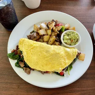 an omelet with potatoes and guacamole