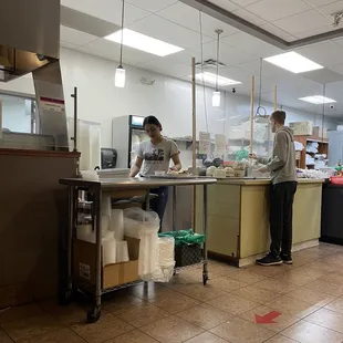 two people working in a kitchen