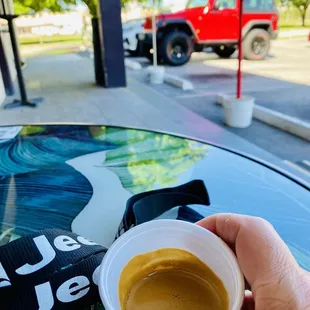 a person holding a cup of coffee