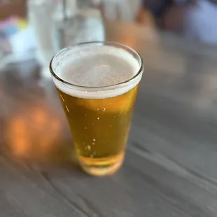 a glass of beer on a table