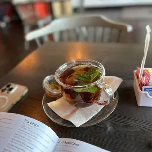 a cup of tea and a book on a table