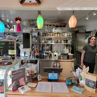 a woman standing behind a counter