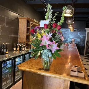 a vase of flowers on a bar