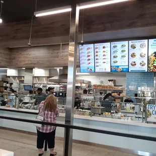 a woman standing in front of the counter