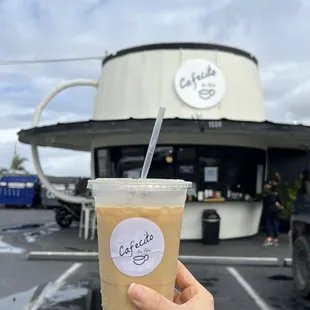 a hand holding a cup of coffee