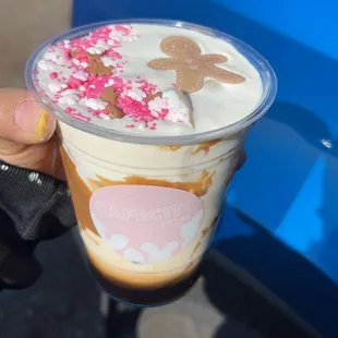 a hand holding a cup of ice cream