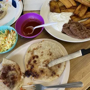 Pupusa with cheese and beans, pupusa with pork cheese and beans "con todo" and plantains cream and beans.