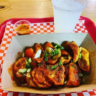 The Chili Momo has a sweet, sour and spicy sauce complete with tofu and veggie stuffed Momo, tomatoes, onions and peppers.