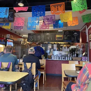 people sitting at tables in a mexican restaurant