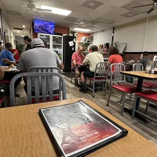 people sitting at tables in a restaurant