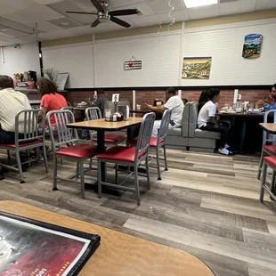 people sitting at tables in a restaurant
