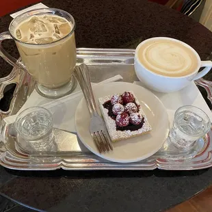 a cup of cappuccino and a slice of cake