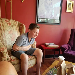 a man sitting in a chair in a living room