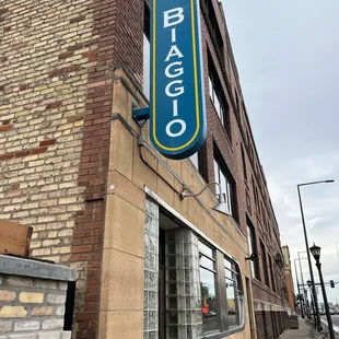 a blue sign on a brick building