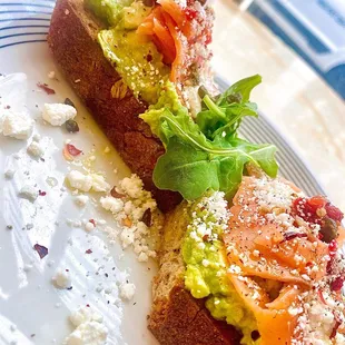 two pieces of bread with avocado and tomatoes