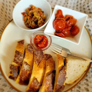 My snack, consisting of freshly baked boule, sundried tomatoes, tapenade &amp; Calabrian chili paste