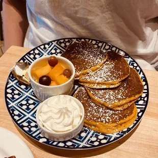 Pumpkin pancakes with fruit cup and whipped cream