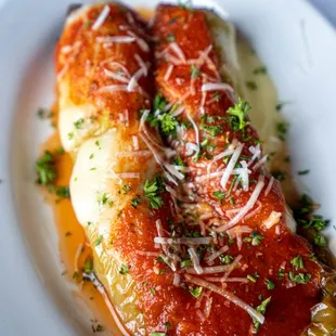 two enchillas on a white plate