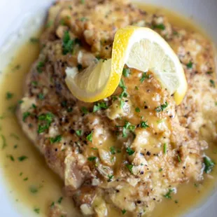 a plate of food with a lemon slice
