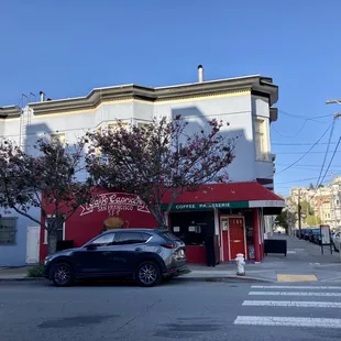 a car parked in front of a cafe
