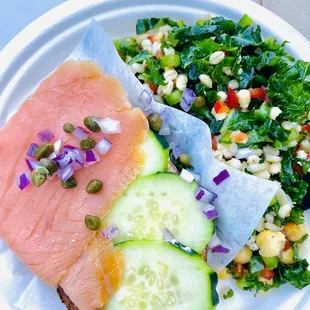 a plate of food with a salad and salmon