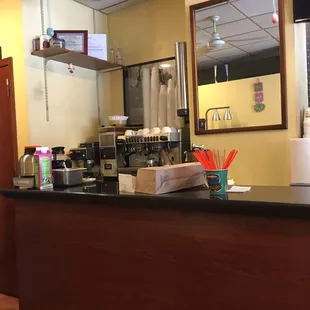 a coffee shop counter with a mirror