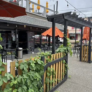 a patio with tables and umbrellas