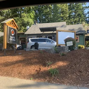 a car parked in front of a coffee shop