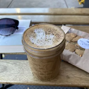 Black pepper and cardamom latte with vegan chocolate chip cookie