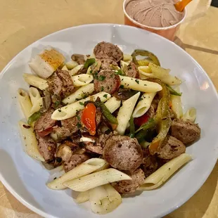 a plate of pasta with meat and vegetables