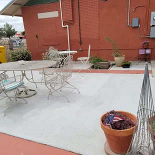 a patio with a table and chairs
